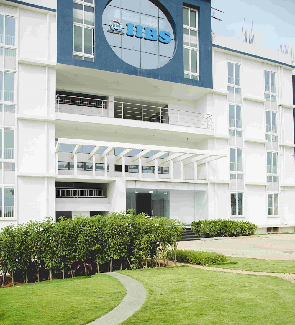 a large white building with a blue and white sign