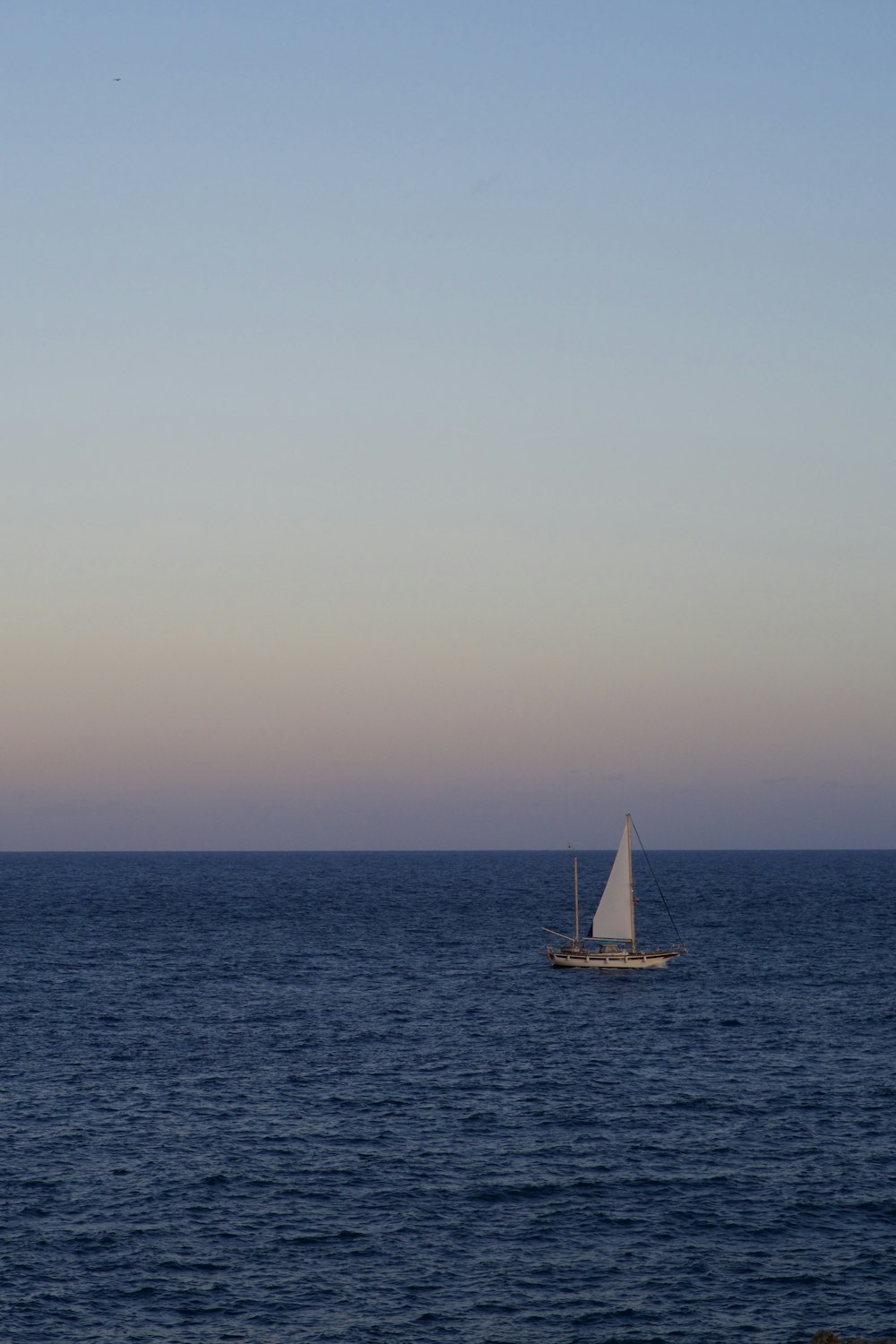 a sailboat in the middle of the ocean