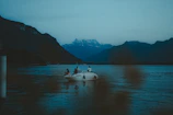 Tourists enjoying a boat ride on the tranquil waters of Kodaikanal lake.