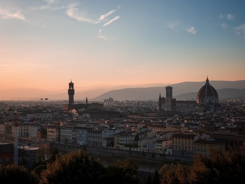 a view of a city at sunset from a hill