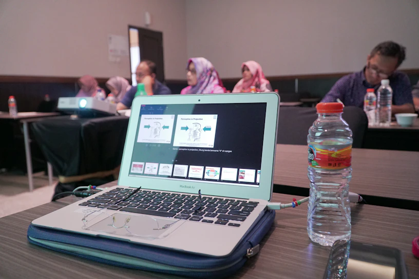 A professional consultant presenting a global expansion strategy on a sleek laptop in a modern office.