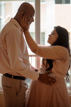 A compassionate doctor discussing IVF options with a hopeful couple in a bright, welcoming clinic room