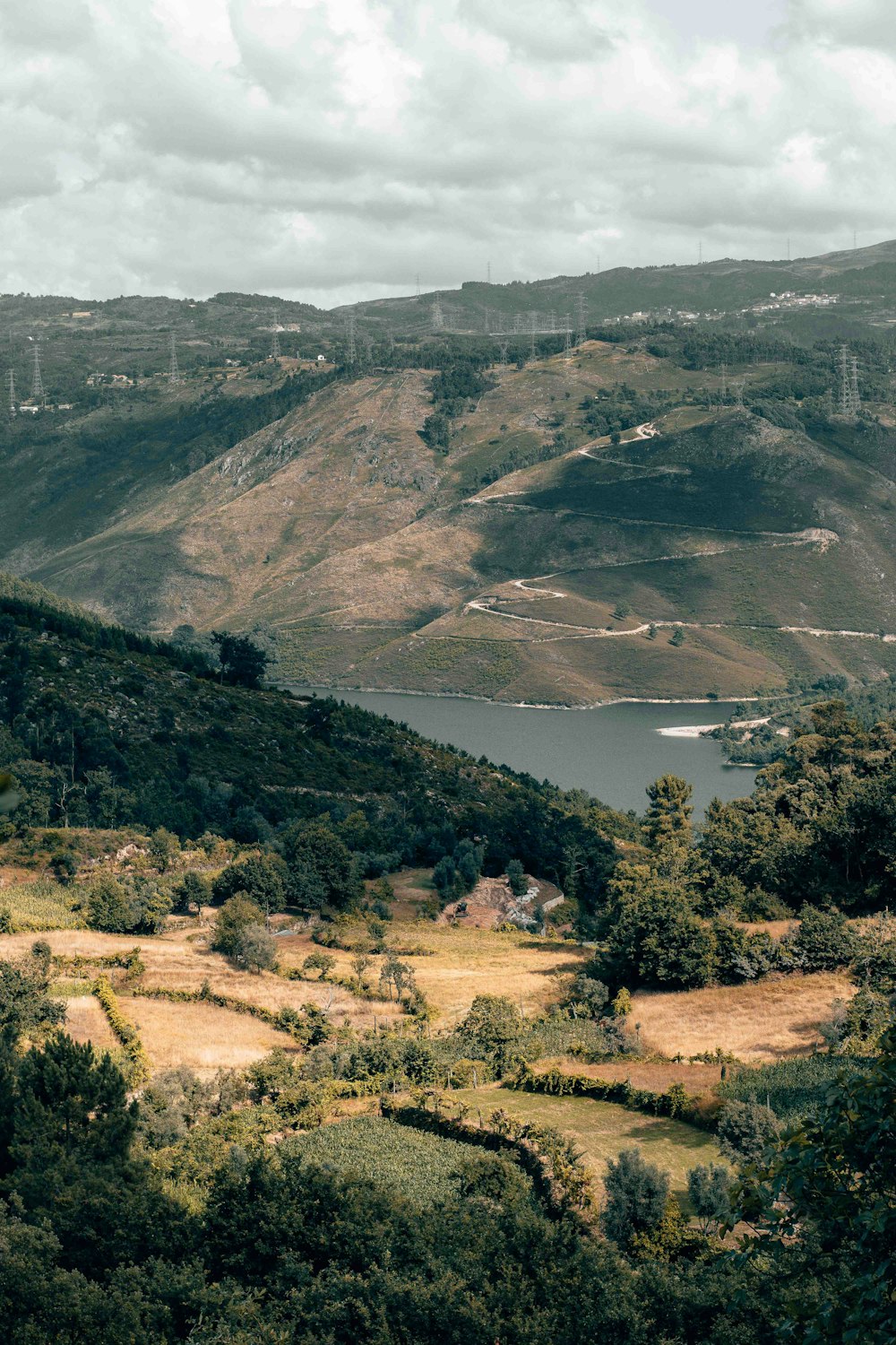 a scenic view of a lake surrounded by mountains