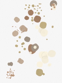 A series of abstract, paint-like circles and dots in varying sizes and shades of beige, brown, and olive are scattered across a white background. The pattern is random, giving it a playful and artistic appearance.