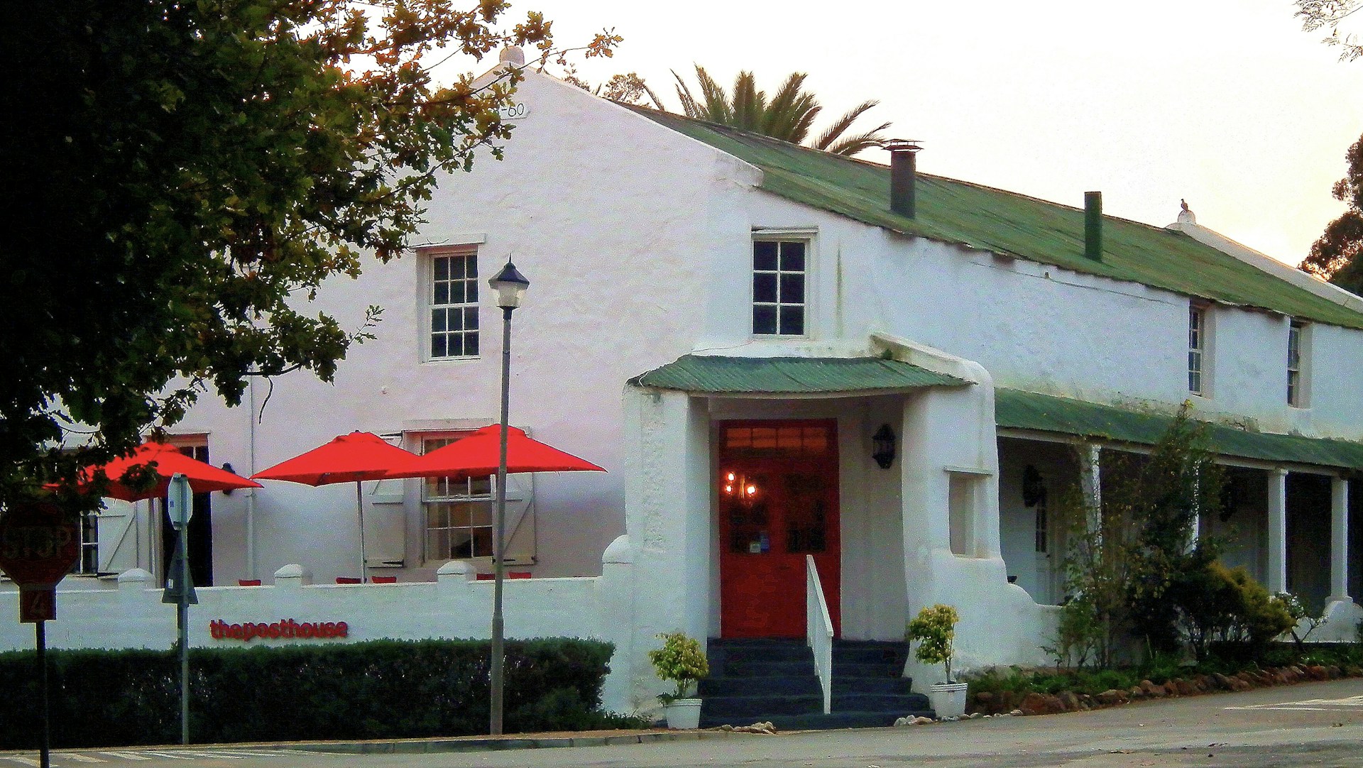 The charming exterior of Restaurate Serbal nestled among pine trees, showcasing its blend of modern and rural architecture.