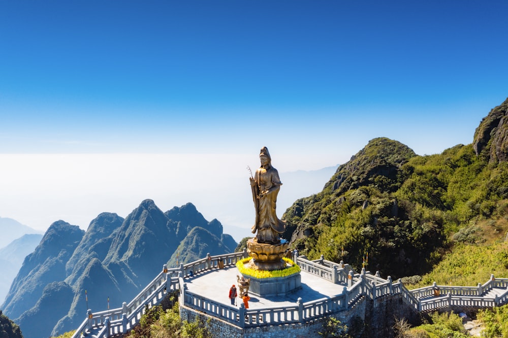 a statue of buddha on top of a mountain