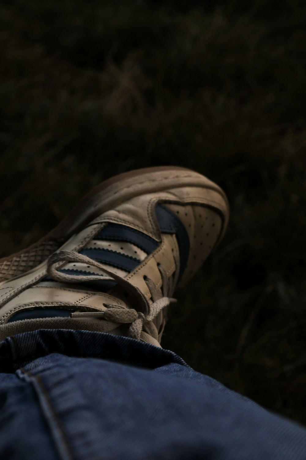 a person's feet in a pair of blue jeans