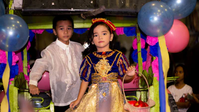 Kids dressed up in vibrant party wear, ready for a celebration.