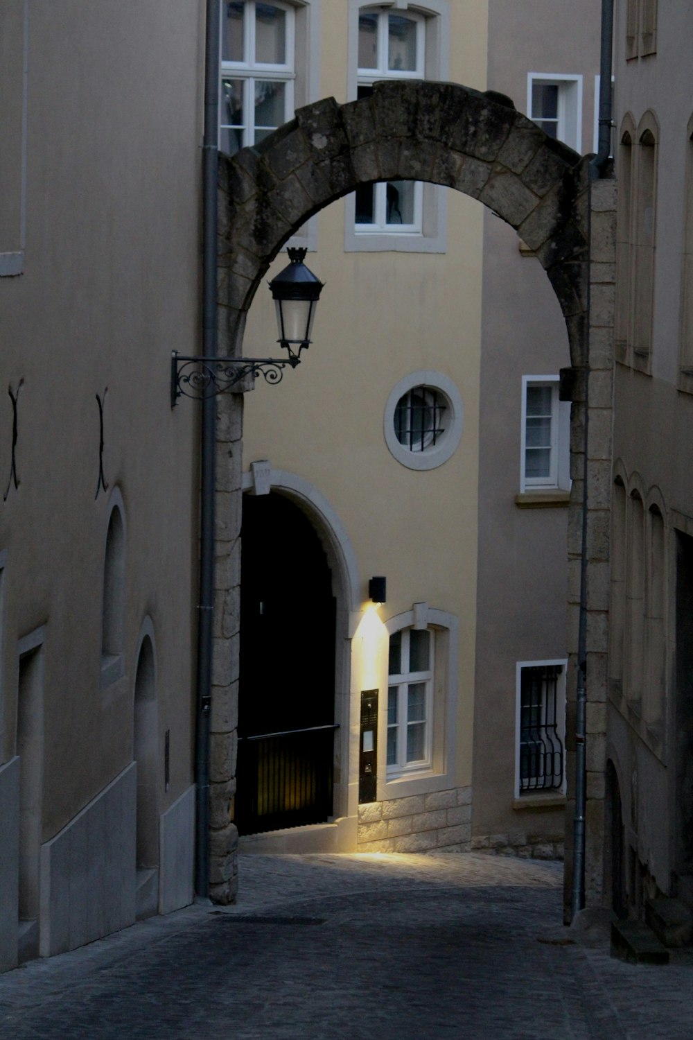 a narrow street with a light on the side of it