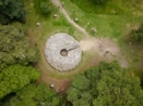 an aerial view of a large rock in the middle of a forest