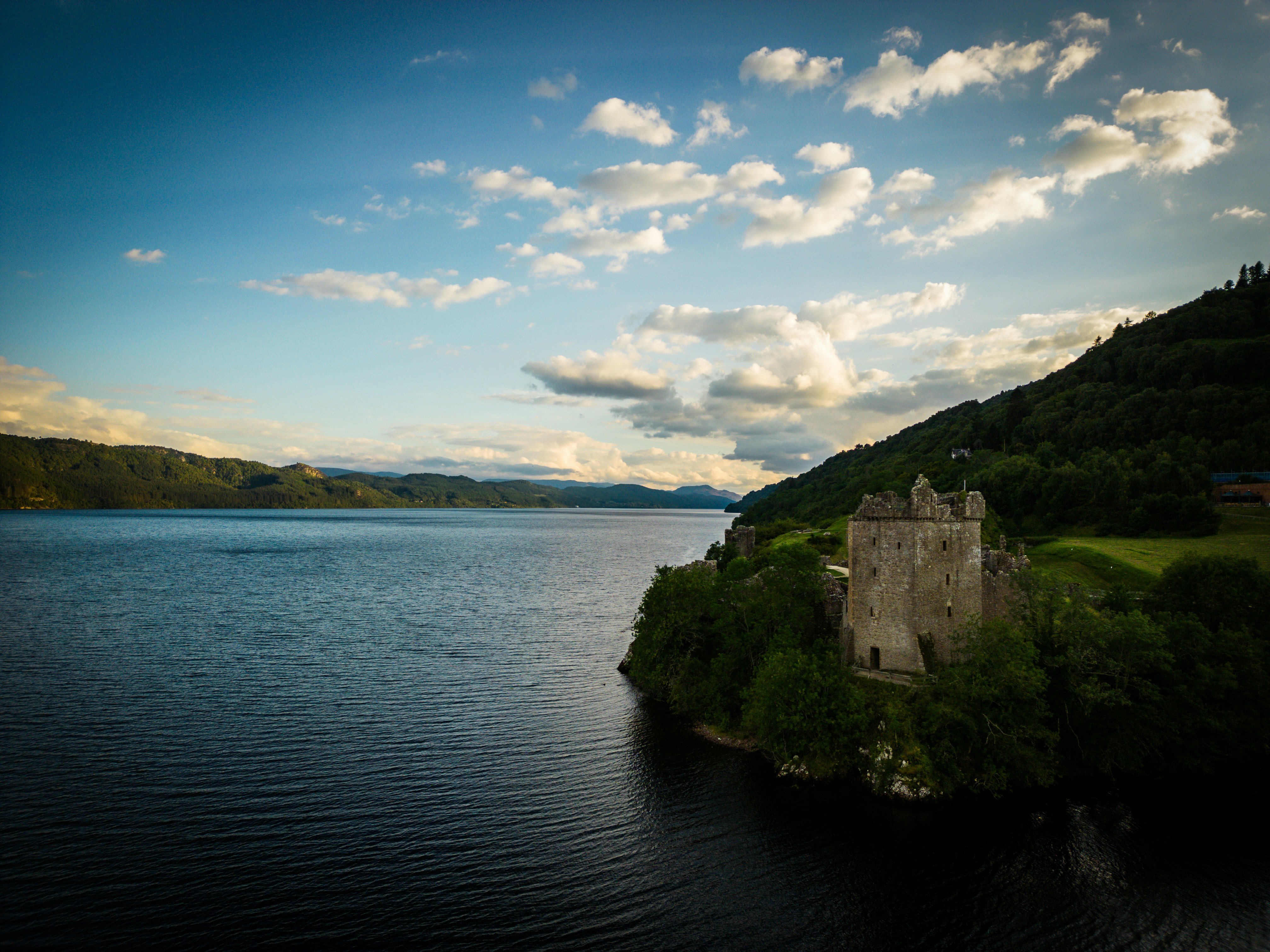 a castle on a small island in the middle of a lake, Urquhart Castle, Loch Ness, Scotland