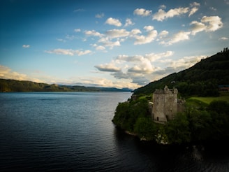a castle on a small island in the middle of a lake