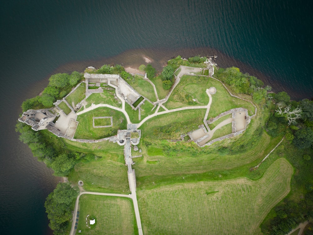 an aerial view of a castle in the middle of a body of water