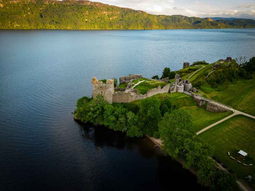 a castle on a small island in the middle of a lake