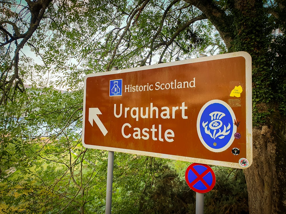 a road sign pointing to urqu hart castle