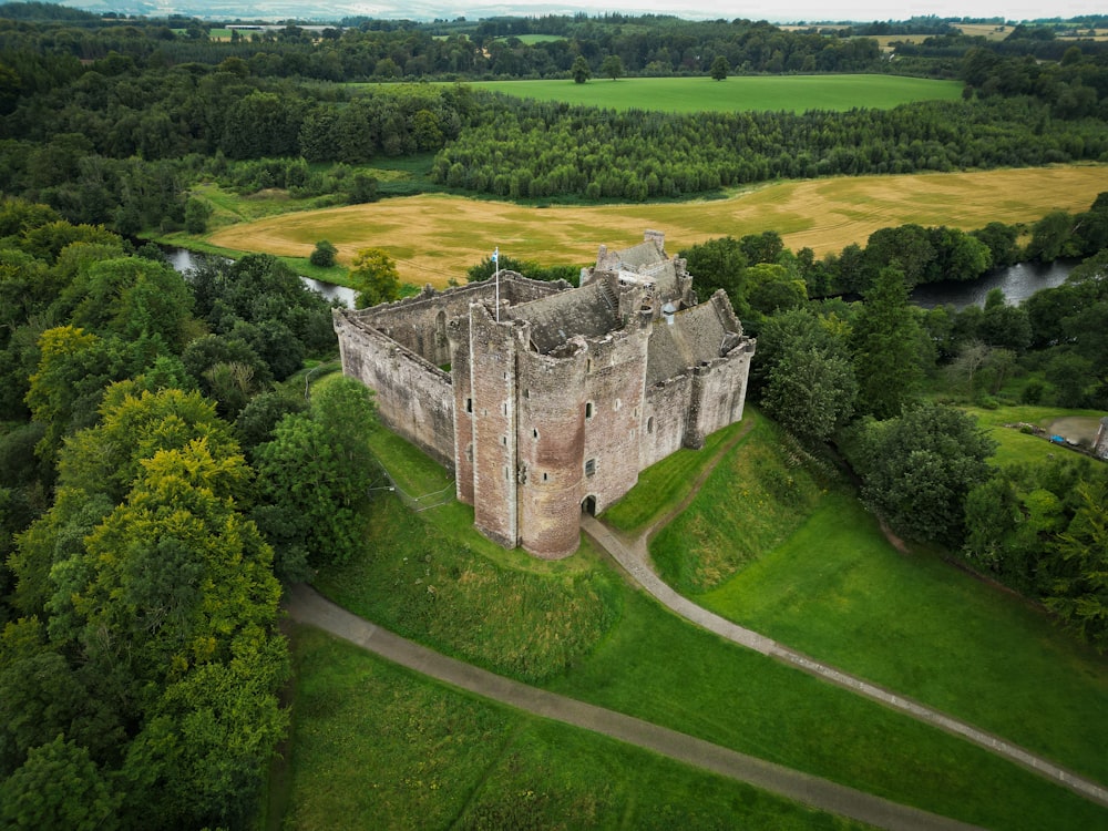 an aerial view of a castle surrounded by trees