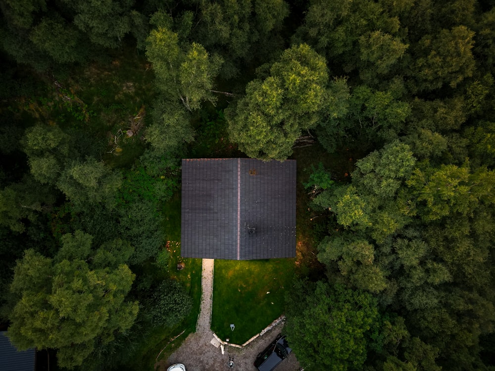 an aerial view of a house surrounded by trees