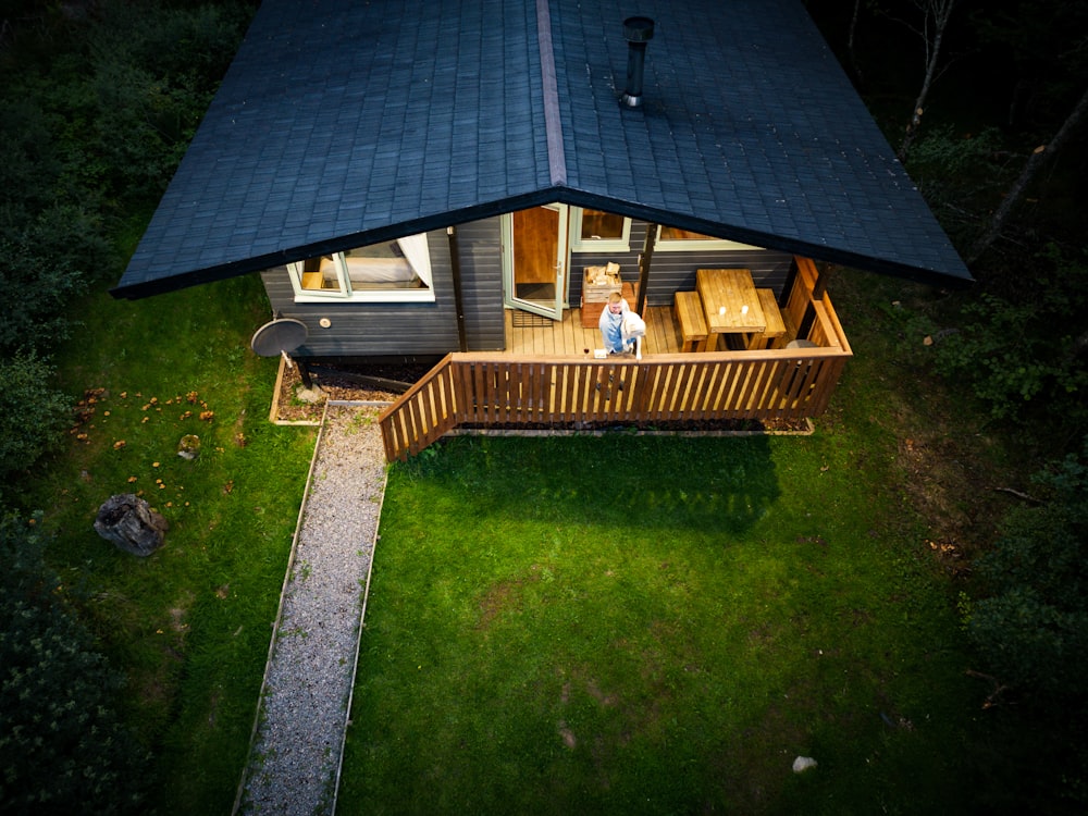 a person standing on a deck in front of a house