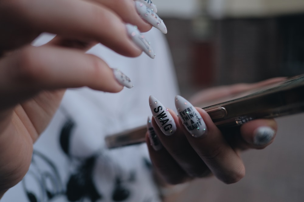 a woman holding a cell phone with a design on it