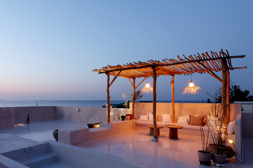 an outdoor seating area with a view of the ocean