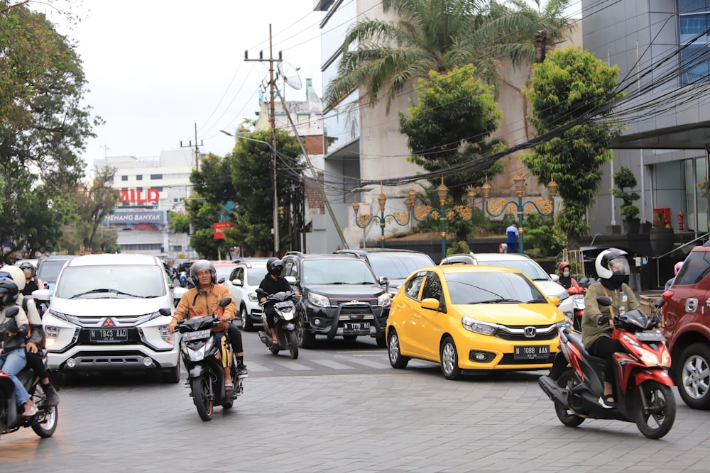 a group of people riding motorcycles down a street