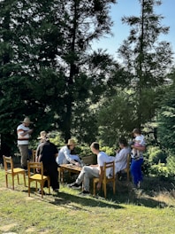 a group of people sitting around a wooden table