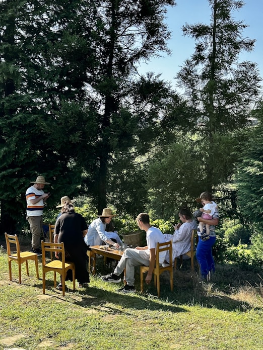 a group of people sitting around a wooden table