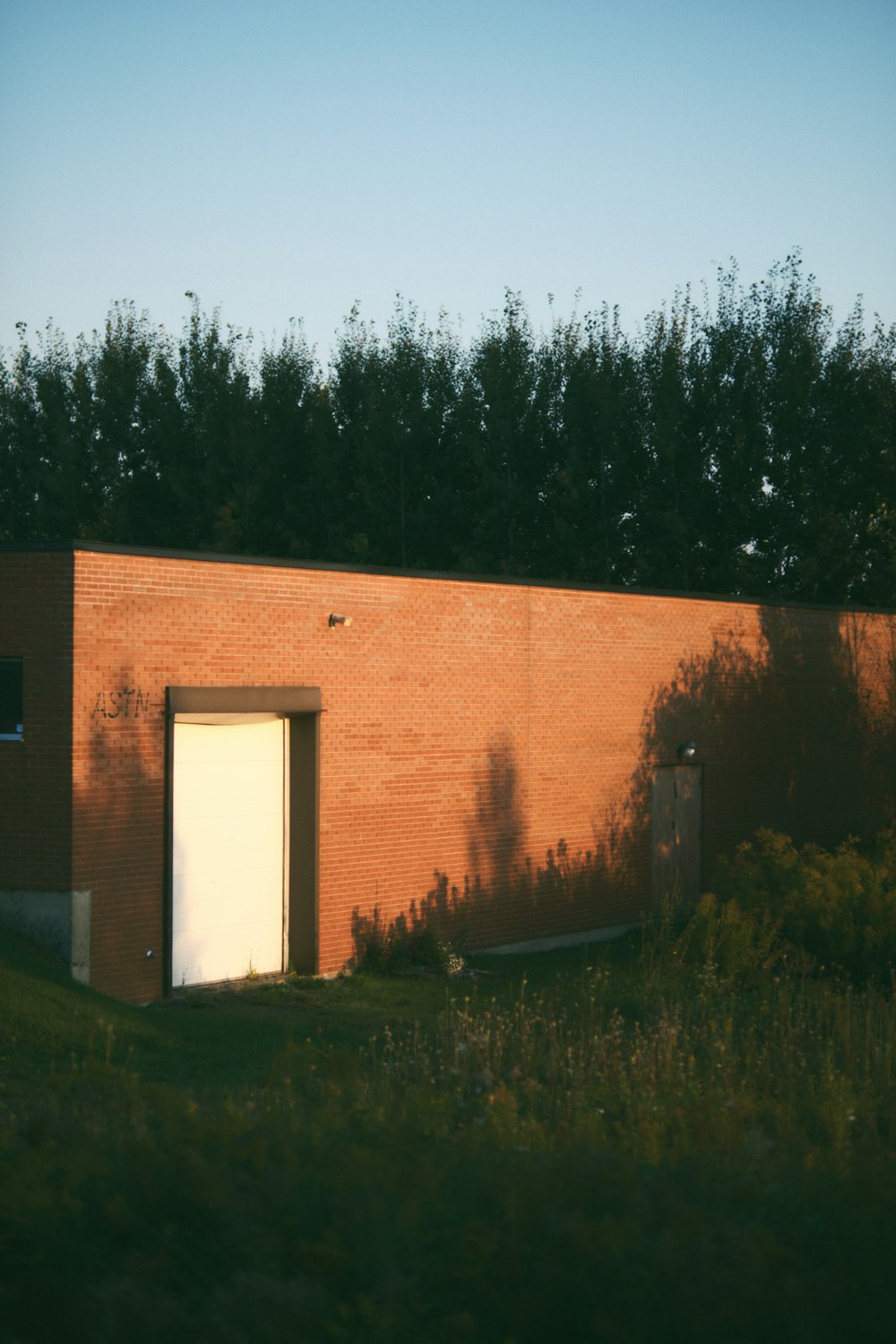 a red brick building with a white door