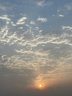 A serene sunrise breaking through soft clouds, symbolizing hope and new beginnings.