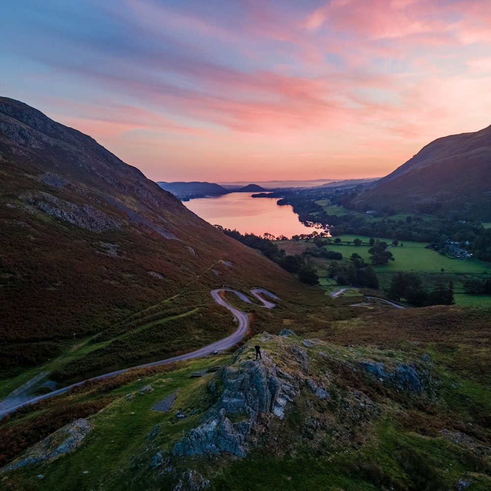 a scenic view of a winding road in the mountains