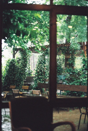 A cozy outdoor loveseat nestled among lush greenery, inviting relaxation.