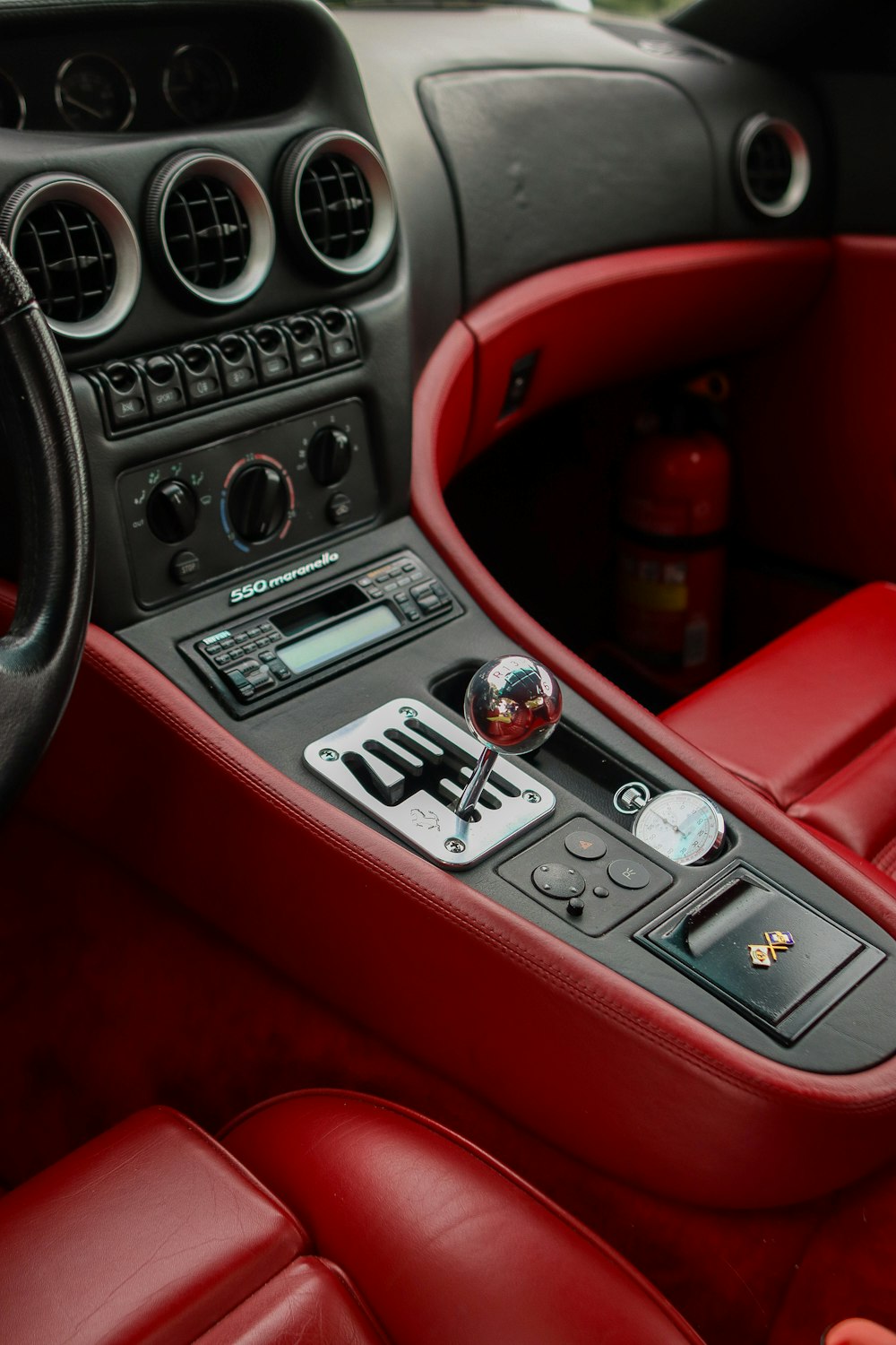 the interior of a car with red leather seats