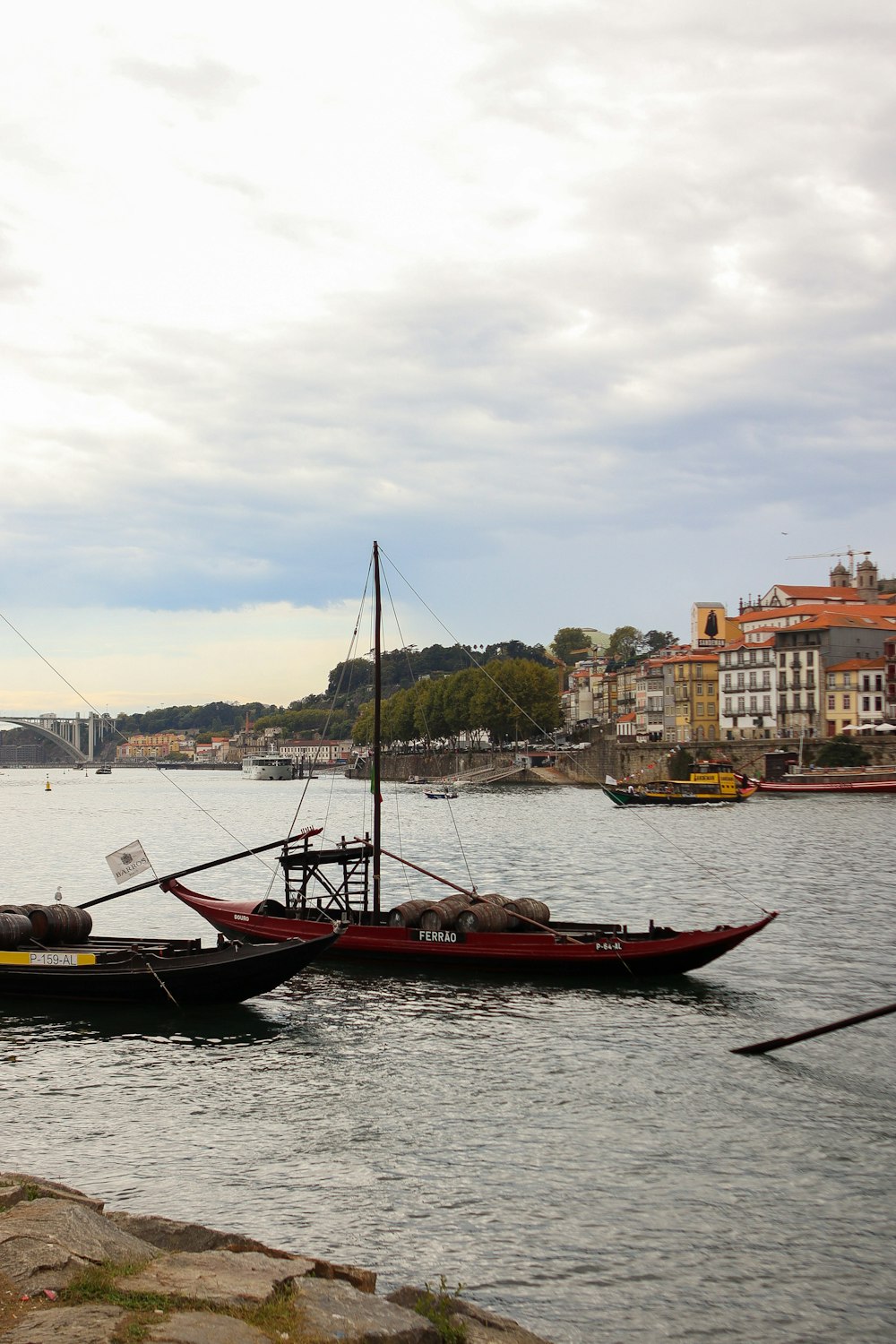 a couple of boats floating on top of a lake