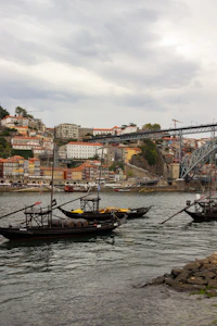 a couple of boats floating on top of a body of water