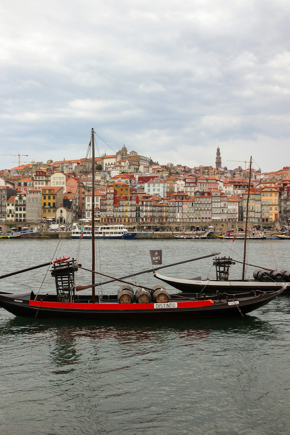 two boats in the water with a city in the background