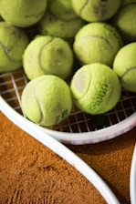 a bunch of tennis balls sitting on a racket