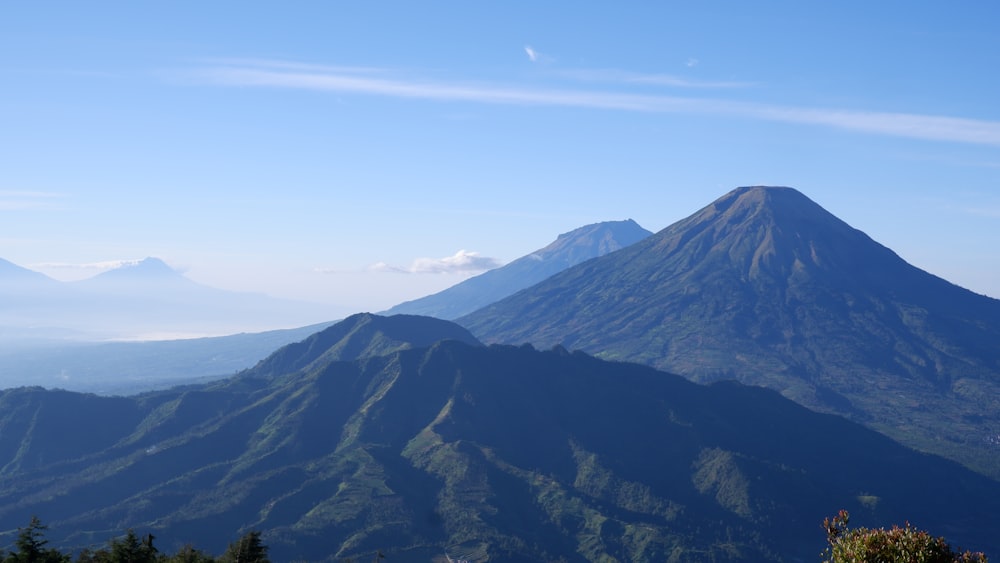 a view of a mountain with a blue sky in the background