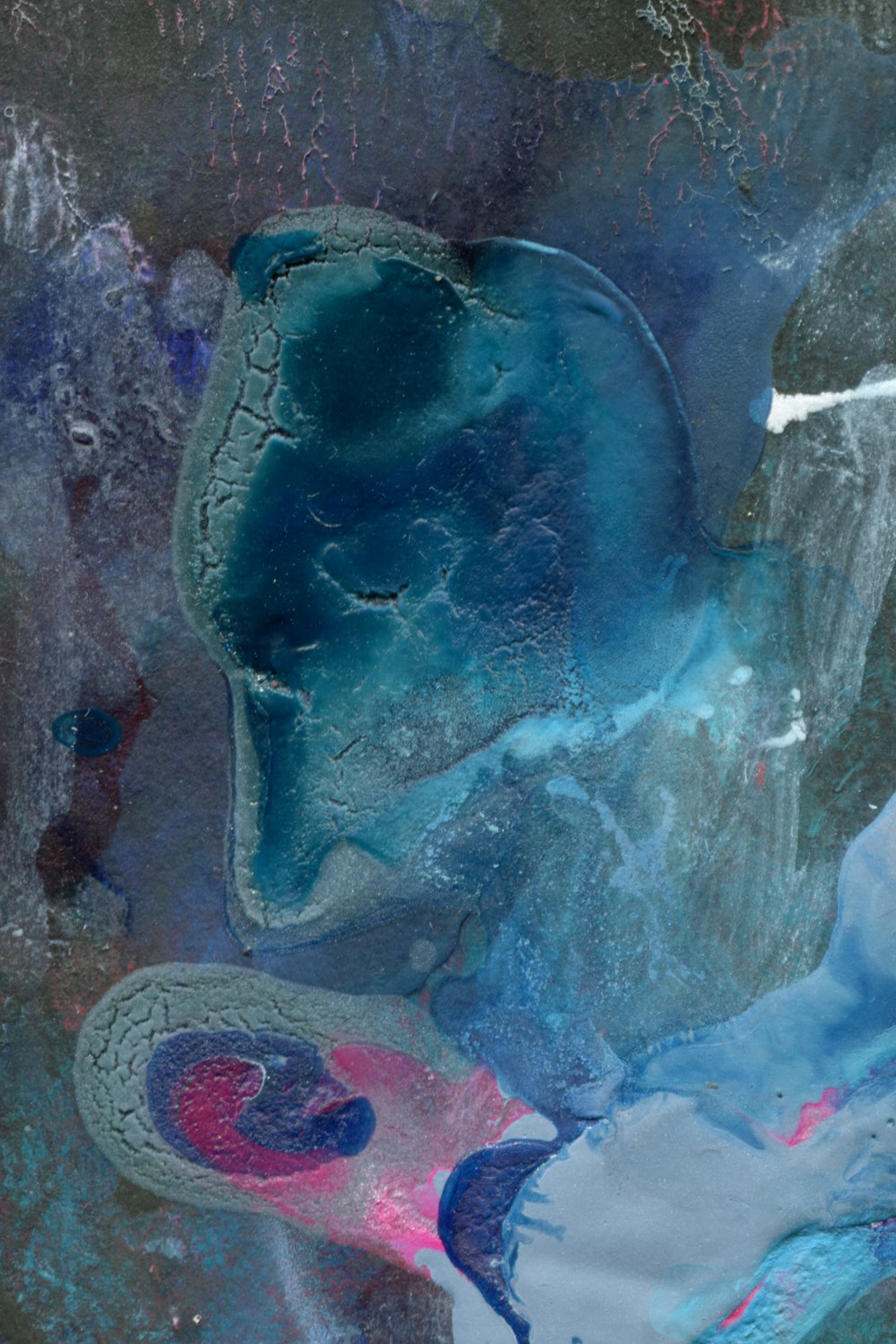 a close up of a piece of art with blue and pink colors