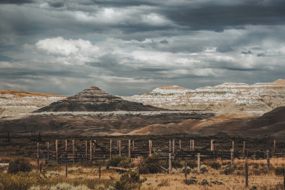 a mountain range with a cloudy sky in the background