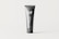 A sleek, gray tube stands vertically against a light background. The tube is primarily dark gray with 'black tube mockups' written in white text vertically. The letters 'MF' are prominently displayed at the top section of the tube.
