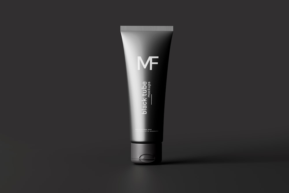 a tube of men's shaving cream on a black background