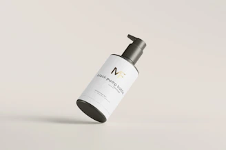 Close-up of a sleek supplement bottle with a minimalist label on a white background.