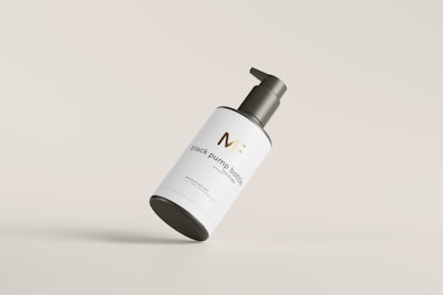 Close-up of a supplement bottle with a matte black and gold label, set against a clean white background.