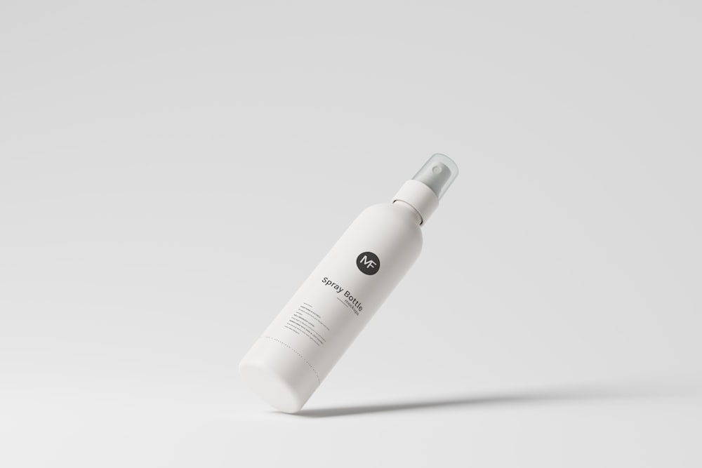 a white bottle of lotion on a white background