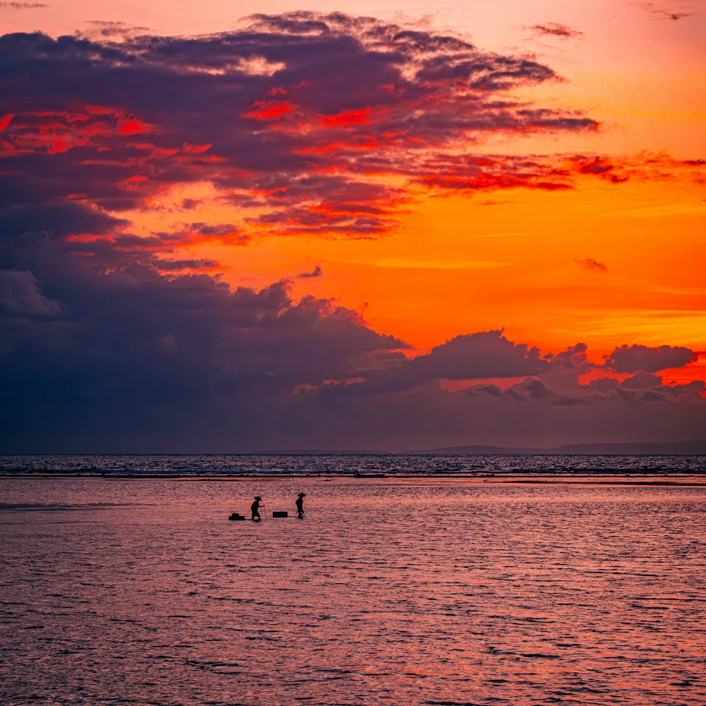 a couple of people on a boat in the water