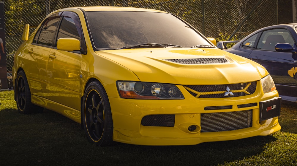 a yellow car parked next to a blue car