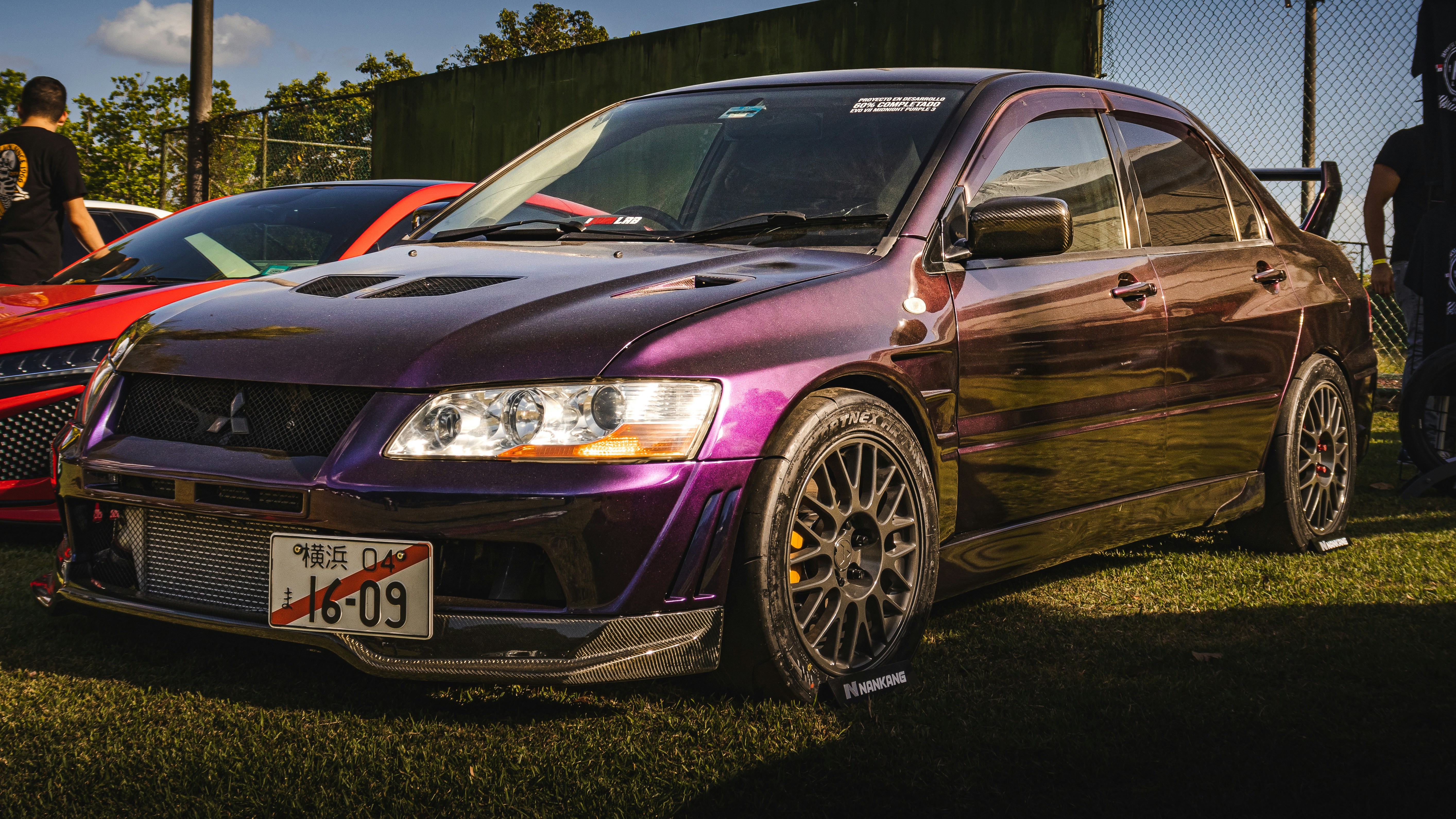 a purple car parked next to a red car