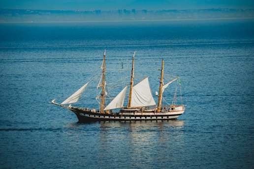 a sailboat sailing across a large body of water