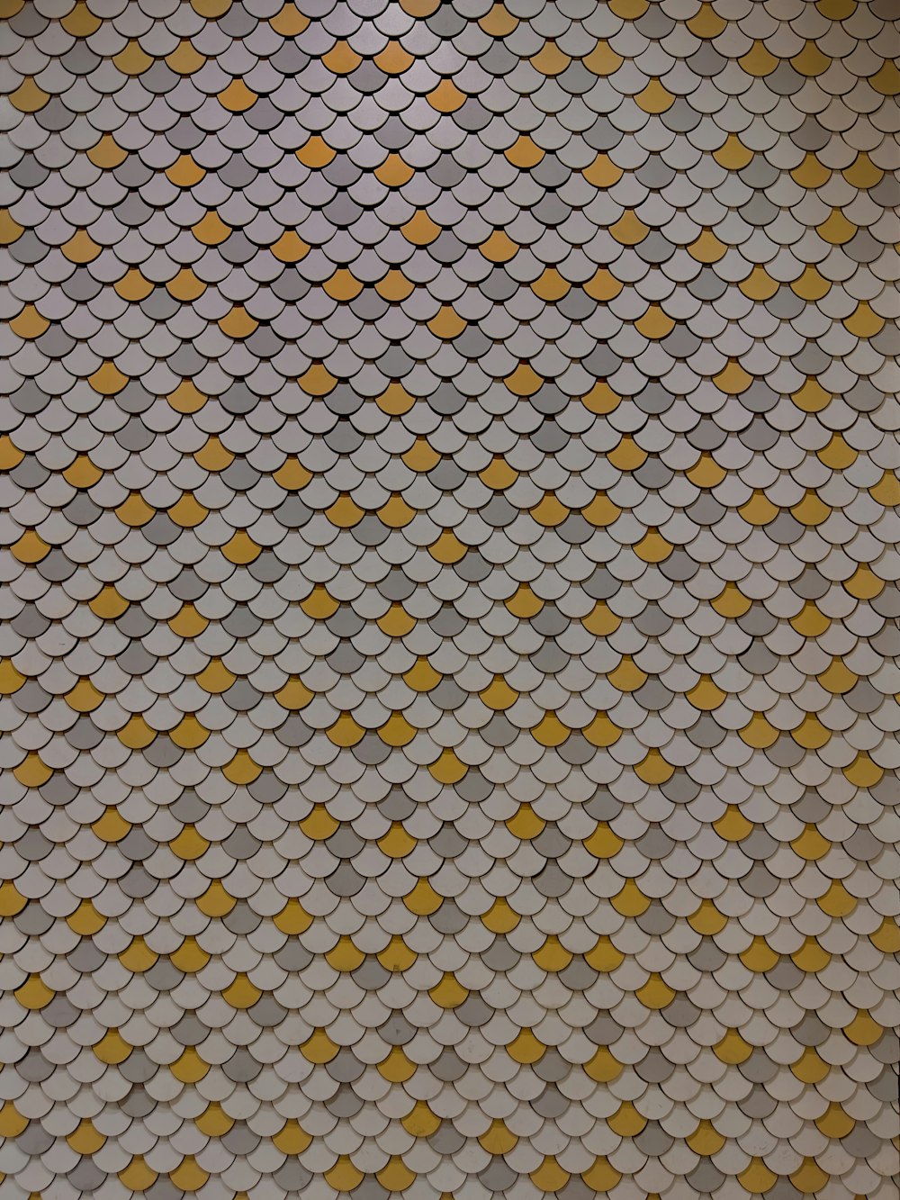 a tiled floor with yellow and white tiles