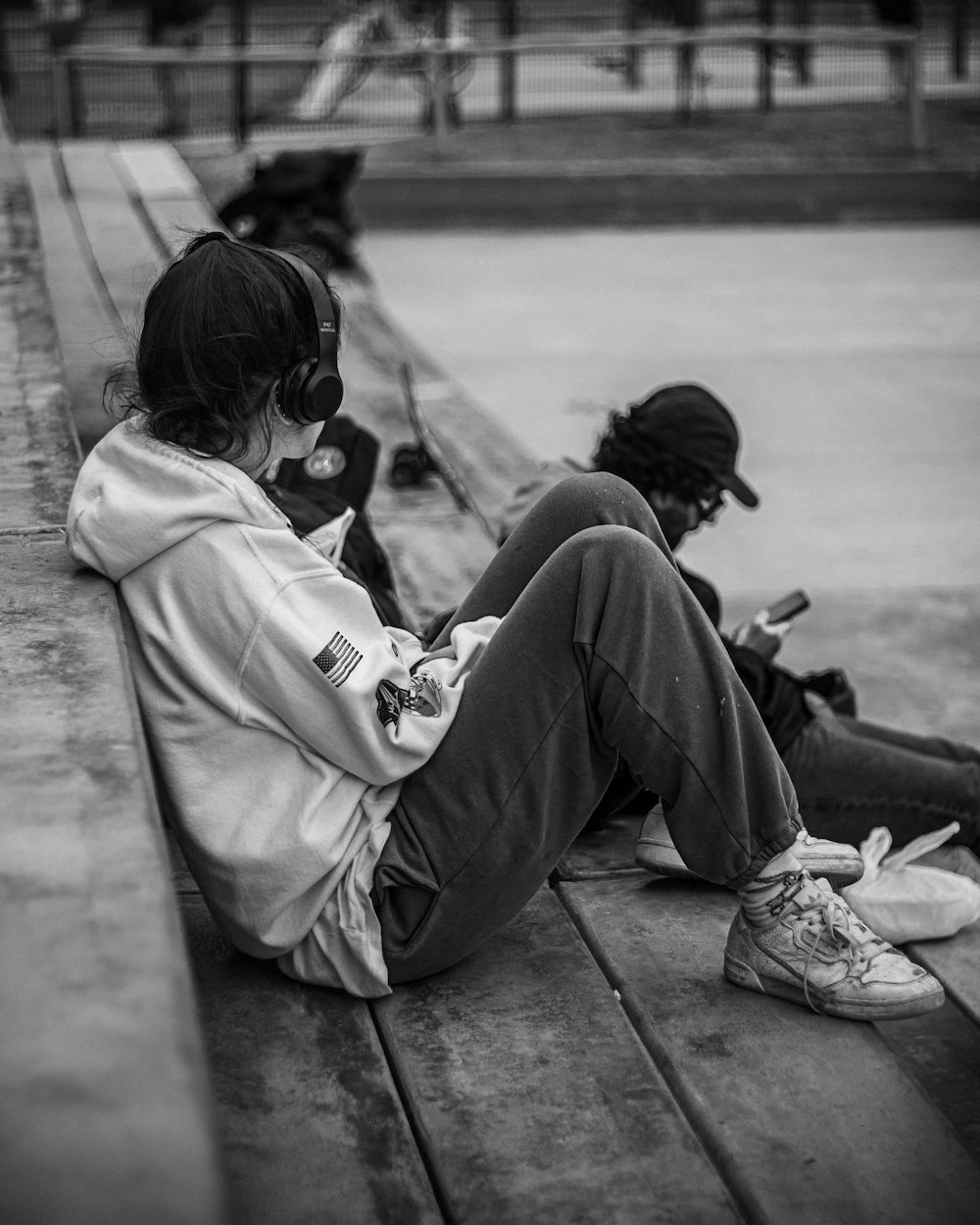 a person sitting on a bench with headphones on